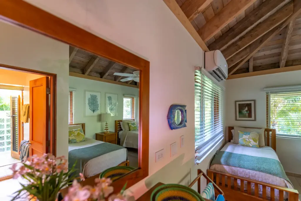 one of the bedrooms at Beachcomber villa with two beds.